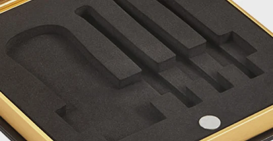 Custom molded pulp and foam inserts inside a rigid box